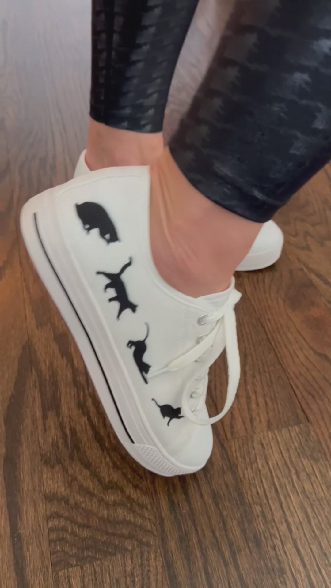 Low top sneakers with cat silhouettes